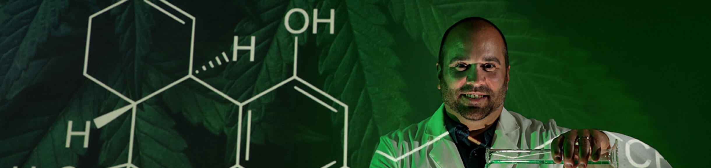 Nick Dipatrizio in front of the chemical symbol for cannabinoids