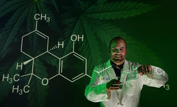 Nick Dipatrizio in front of the chemical symbol for cannabinoids